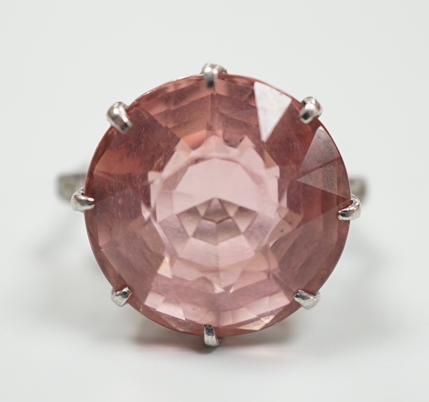 A white metal and circular cut pink tourmaline set dress ring, with three stone graduated diamond set shoulders, size I/J, gross weight 6.6 grams